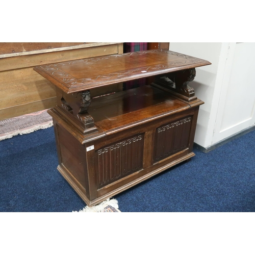 72 - A 20th century stained oak metamorphic monks bench with rectangular top/back on carved lion form arm... 