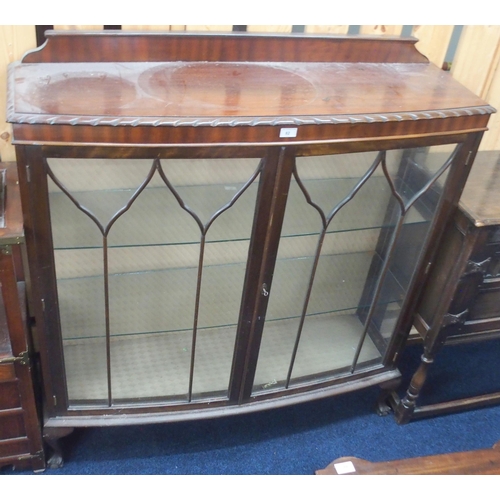 82 - A 20th century mahogany bow fronted two door glazed display cabinet on ball and claw supports, 130cm... 