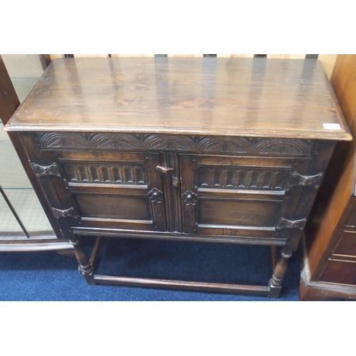 83 - A 20th century oak Jacobean style two door side cabinet on turned supports joined by stretchers, 91c... 