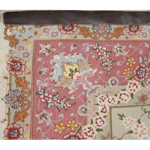 91 - A cream ground fine pile Isfahan rug with multicoloured central medallion and spandrels on floral pa... 