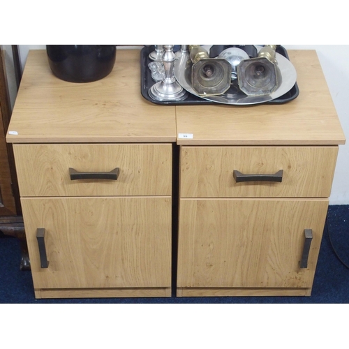 99 - A pair of contemporary beech veneered bedside cabinets with single drawers over cabinet doors on pli... 