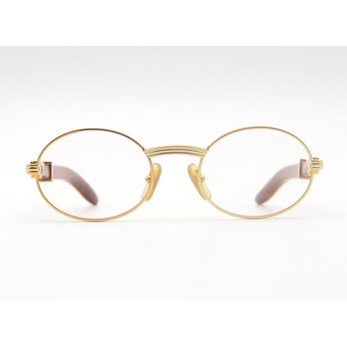 436 - A pair of Cartier gold-tone glasses, with wooden temples, the bridge marked 