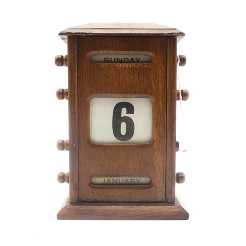 439 - An early-20th century oak perpetual desk calendar, measuring approx. 21cm in height