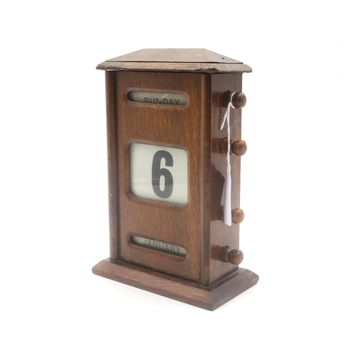 439 - An early-20th century oak perpetual desk calendar, measuring approx. 21cm in height