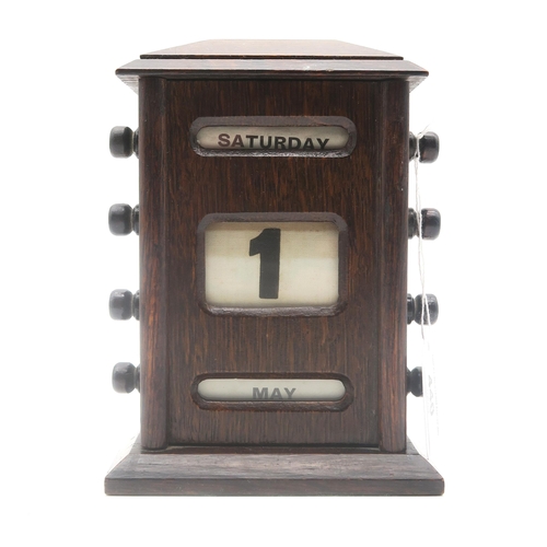 440 - An early-20th century stained oak perpetual desk calendar, measuring approx. 17cm in height 