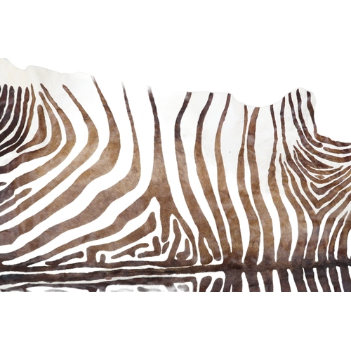 2179 - A 20TH CENTURY ZEBRA PATTERNED COW HIDE RUG 211cm long x 187cm wide (measured from widest points)... 