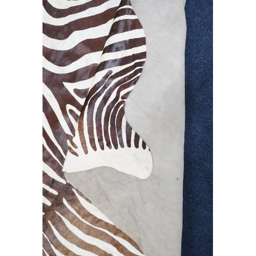 2179 - A 20TH CENTURY ZEBRA PATTERNED COW HIDE RUG 211cm long x 187cm wide (measured from widest points)... 