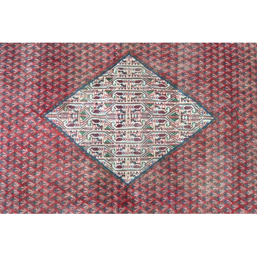 2180 - A RED GROUND ARAAK BOTTEH DESIGN RUG with cream geometric patterned diamond central medallion and ma... 