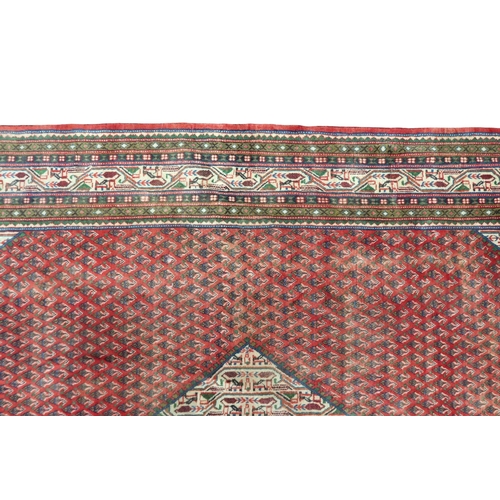 2180 - A RED GROUND ARAAK BOTTEH DESIGN RUG with cream geometric patterned diamond central medallion and ma... 