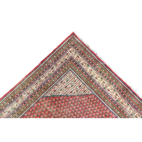 2180 - A RED GROUND ARAAK BOTTEH DESIGN RUG with cream geometric patterned diamond central medallion and ma... 