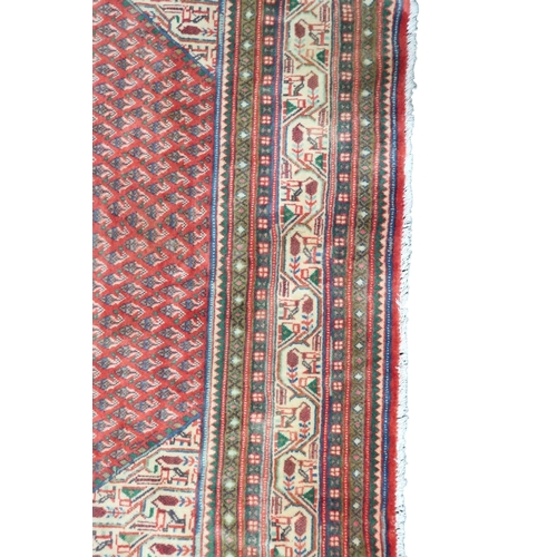 2180 - A RED GROUND ARAAK BOTTEH DESIGN RUG with cream geometric patterned diamond central medallion and ma... 