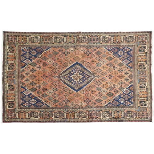 2181 - A TERRACOTTA GROUND JOSHAGAN RUG with dark blue diamond central medallion and matching spandrels on ... 