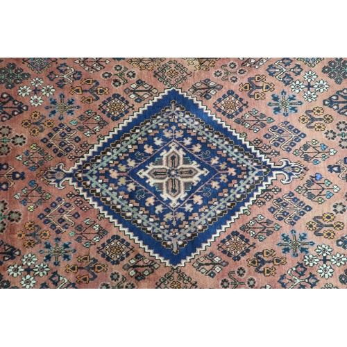 2181 - A TERRACOTTA GROUND JOSHAGAN RUG with dark blue diamond central medallion and matching spandrels on ... 