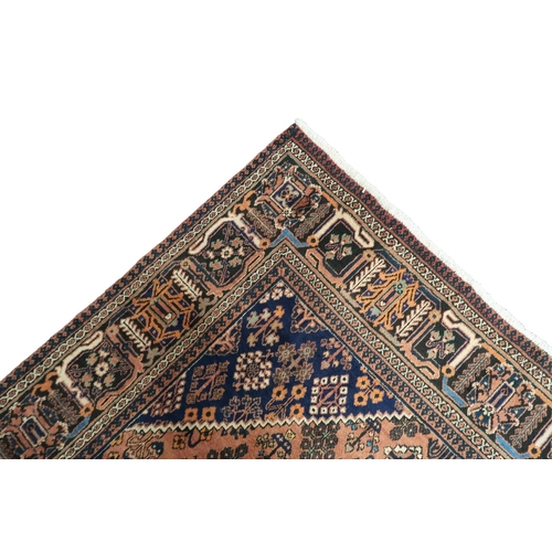 2181 - A TERRACOTTA GROUND JOSHAGAN RUG with dark blue diamond central medallion and matching spandrels on ... 