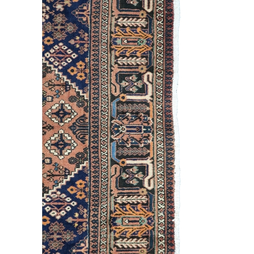 2181 - A TERRACOTTA GROUND JOSHAGAN RUG with dark blue diamond central medallion and matching spandrels on ... 