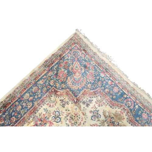 2183 - AN IVORY GROUND AUBUSSON STYLE RUG with multicoloured floral patterned ground within shaped blue flo... 