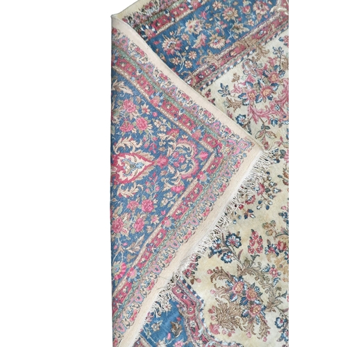 2183 - AN IVORY GROUND AUBUSSON STYLE RUG with multicoloured floral patterned ground within shaped blue flo... 