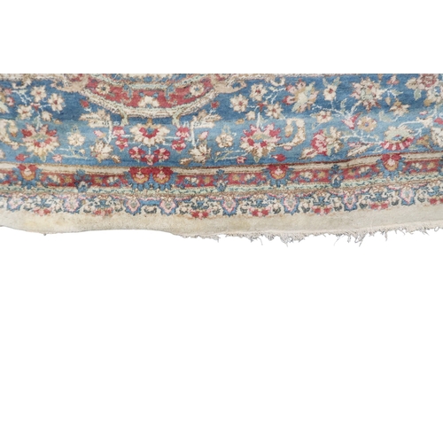 2183 - AN IVORY GROUND AUBUSSON STYLE RUG with multicoloured floral patterned ground within shaped blue flo... 