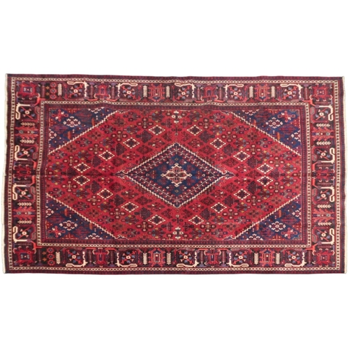 2184 - A DARK RED JOSHAGAN RUG with dark blue diamond medallion and matching spandrels on geometric pattern... 