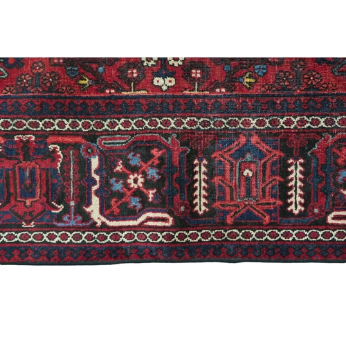 2184 - A DARK RED JOSHAGAN RUG with dark blue diamond medallion and matching spandrels on geometric pattern... 