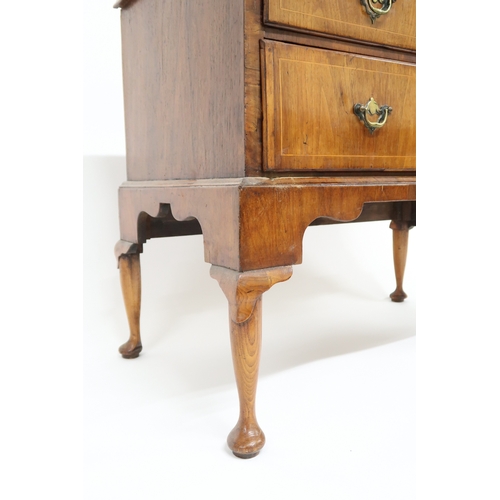 2015 - A GEORGIAN WALNUT VENEERED CHEST OF DRAWERS with rectangular cross banded veneer top over two short ... 