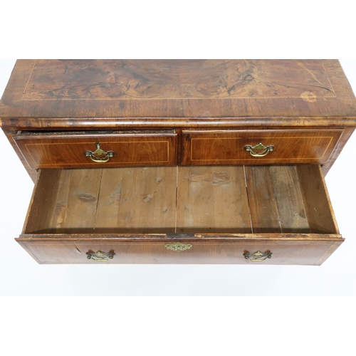 2015 - A GEORGIAN WALNUT VENEERED CHEST OF DRAWERS with rectangular cross banded veneer top over two short ... 