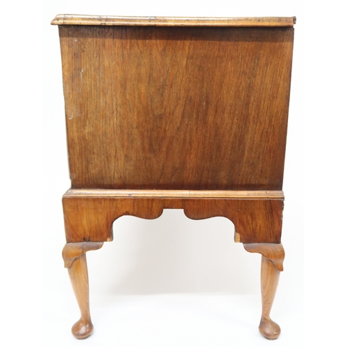 2015 - A GEORGIAN WALNUT VENEERED CHEST OF DRAWERS with rectangular cross banded veneer top over two short ... 