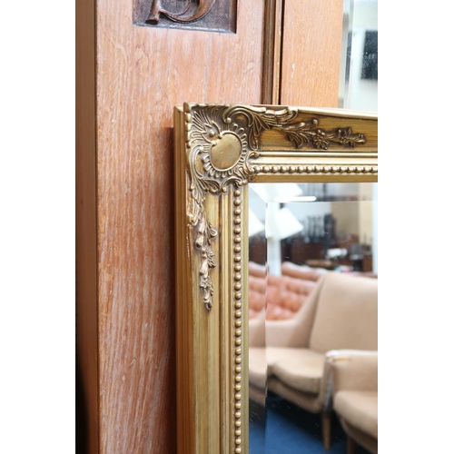 103 - A 20th century gilt framed bevelled glass wall mirror, 136cm high x 106cm wide