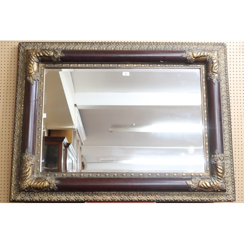 13 - A 20th century reproduction gilt decorated bevelled glass wall mirror, 91cm high x 122cm wide 