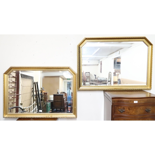 131 - A pair of 20th century gilt framed bevelled glass wall mirrors, 72cm high x 103cm wide (2)