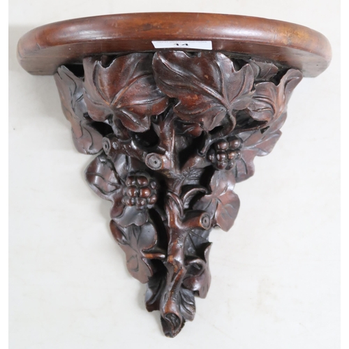 14 - A 19th century mahogany wall sconce extensively carved with acanthus leaves and berries on branch, 2... 