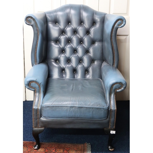 21 - A 20th century blue leather upholstered buttoned wingback armchair on cabriole supports, 105cm high ... 