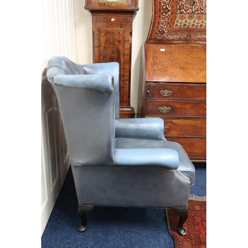 21 - A 20th century blue leather upholstered buttoned wingback armchair on cabriole supports, 105cm high ... 