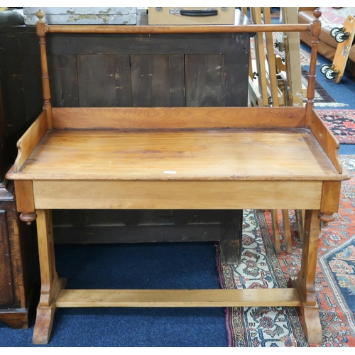 29 - A late 19th century pine wash stand with spindled rail over gallery back on trestle supports, 108cm ... 