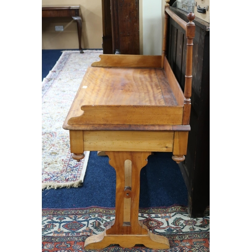 29 - A late 19th century pine wash stand with spindled rail over gallery back on trestle supports, 108cm ... 