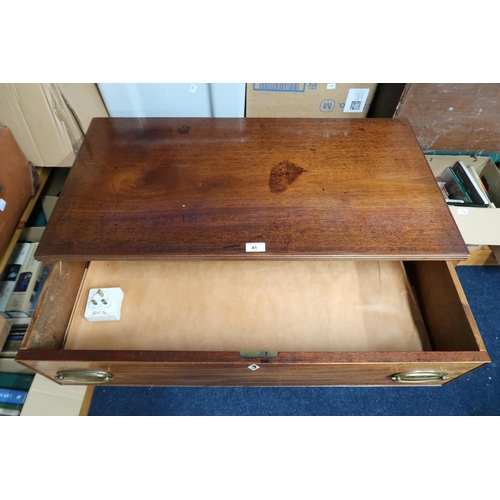 41 - A 19th century mahogany chest of three drawers with brass drawer pulls on shaped supports joined by ... 