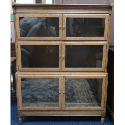 53 - A 20th century oak Minty, Oxford three tier sectional bookcase with glazed doors on turned feet, 118... 