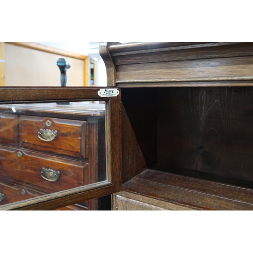 53 - A 20th century oak Minty, Oxford three tier sectional bookcase with glazed doors on turned feet, 118... 