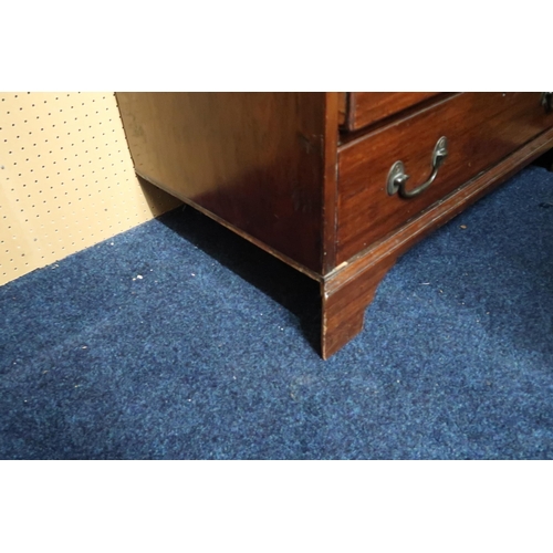 59 - A 19th century mahogany chest of drawers with pull out writing slide over four graduating drawers on... 