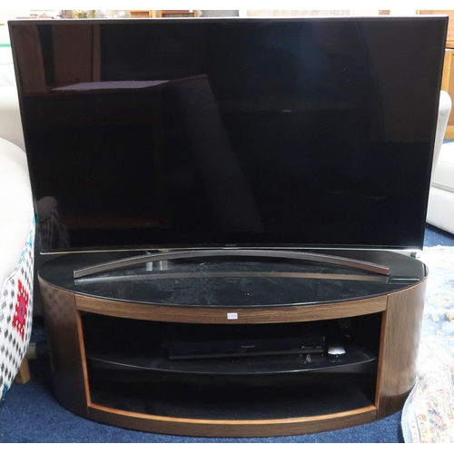 63 - A contemporary Samsung curved screen television, Samsung sound bar, Panasonic free view box and oval... 