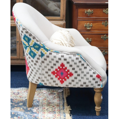 73 - A contemporary tub armchair with kilim patterned upholstered back and cream upholstered seat on turn... 