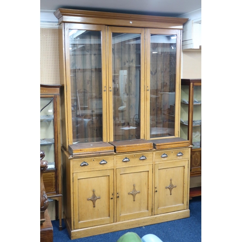 8 - A 19th century white oak glazed library bookcase with moulded cornice over three glazed doors on bas... 