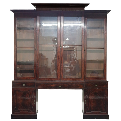 2018 - A LARGE 19TH CENTURY MAHOGANY BREAKFRONT LIBRARY BOOKCASE with stepped moulded cornices over pair of... 