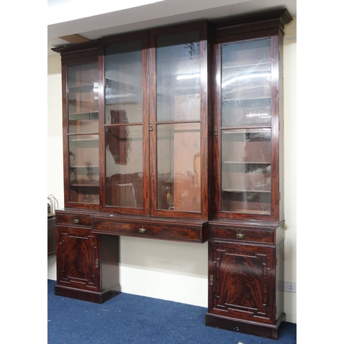 2018 - A LARGE 19TH CENTURY MAHOGANY BREAKFRONT LIBRARY BOOKCASE with stepped moulded cornices over pair of... 