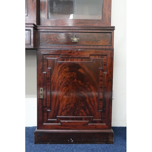 2018 - A LARGE 19TH CENTURY MAHOGANY BREAKFRONT LIBRARY BOOKCASE with stepped moulded cornices over pair of... 