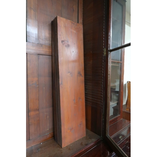 2018 - A LARGE 19TH CENTURY MAHOGANY BREAKFRONT LIBRARY BOOKCASE with stepped moulded cornices over pair of... 