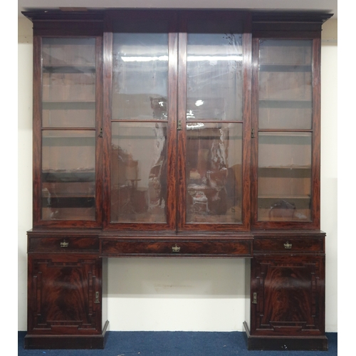 2018 - A LARGE 19TH CENTURY MAHOGANY BREAKFRONT LIBRARY BOOKCASE with stepped moulded cornices over pair of... 