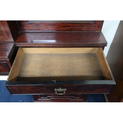 2018 - A LARGE 19TH CENTURY MAHOGANY BREAKFRONT LIBRARY BOOKCASE with stepped moulded cornices over pair of... 