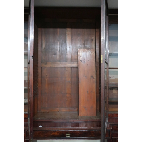 2018 - A LARGE 19TH CENTURY MAHOGANY BREAKFRONT LIBRARY BOOKCASE with stepped moulded cornices over pair of... 