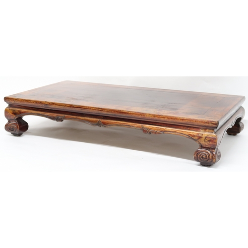 2025 - A 20TH CENTURY CHINESE HARDWOOD LOW OPIUM TABLE converted from a cabinet base with rectangular top o... 